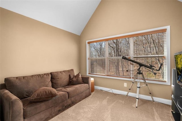 carpeted living room featuring baseboards and vaulted ceiling