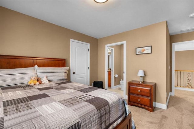 bedroom with connected bathroom, baseboards, light colored carpet, and visible vents