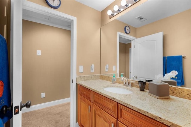 bathroom featuring vanity, baseboards, and visible vents