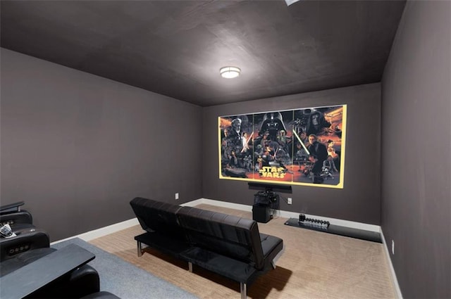 carpeted home theater featuring baseboards