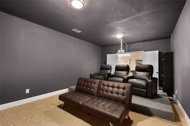 cinema room featuring visible vents, baseboards, and carpet floors