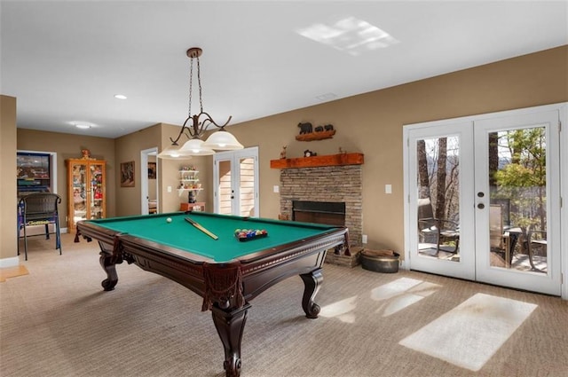 playroom featuring french doors, light carpet, billiards, and a fireplace