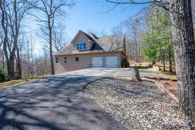 view of property exterior featuring aphalt driveway