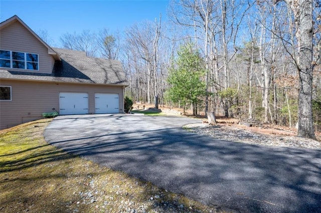 view of side of property featuring a garage and driveway