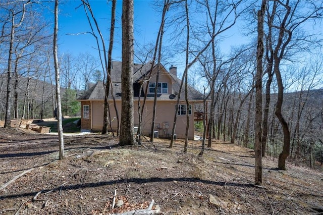 view of property exterior with a chimney