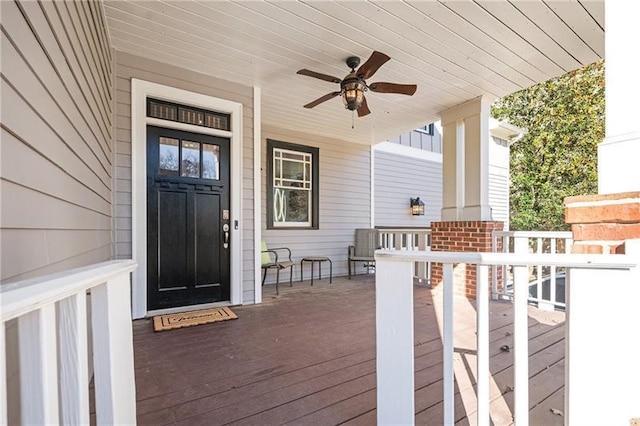 wooden deck featuring a porch and ceiling fan