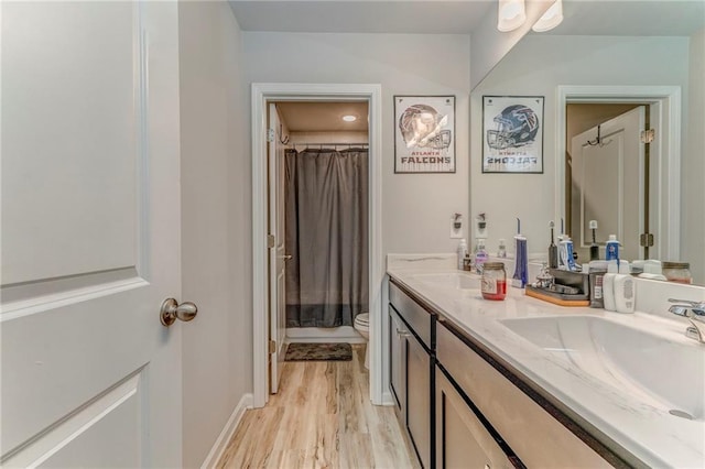 28 Rolling Rock Way, Dallas, GA 30157 - full bath with double vanity, toilet, wood finished floors, a shower with curtain, and baseboards