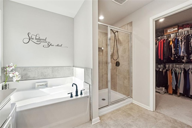 bathroom featuring tile patterned floors, vanity, and separate shower and tub