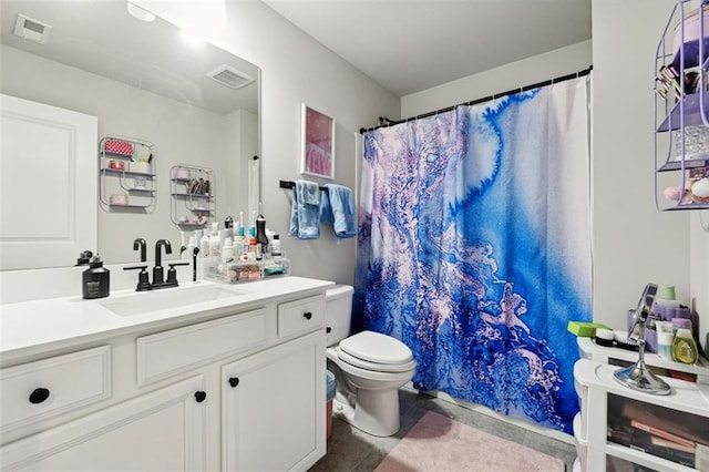 bathroom featuring vanity, toilet, and curtained shower