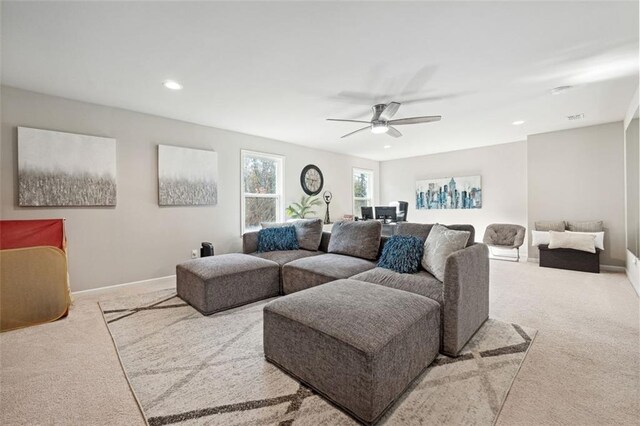 carpeted living room featuring ceiling fan