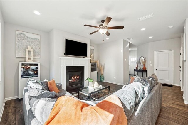 living room featuring dark hardwood / wood-style floors and ceiling fan