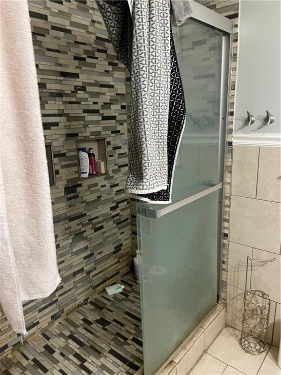 bathroom with tile walls and tile patterned flooring