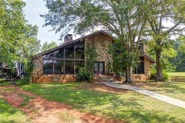 rear view of house featuring a yard