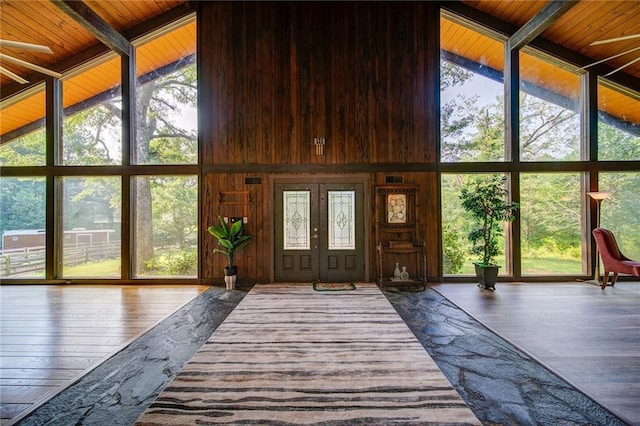 unfurnished sunroom with plenty of natural light, vaulted ceiling with beams, and wooden ceiling