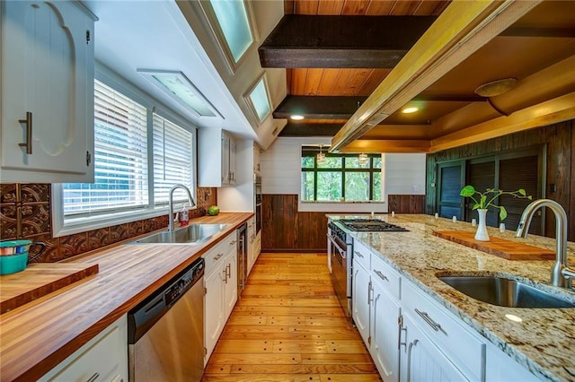 kitchen with white cabinetry, sink, and stainless steel appliances