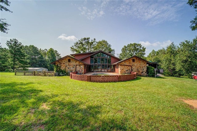 rear view of house with a patio and a lawn