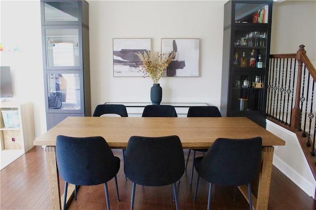 dining room featuring baseboards and hardwood / wood-style floors