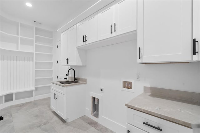 clothes washing area featuring cabinets, washer hookup, hookup for an electric dryer, and sink