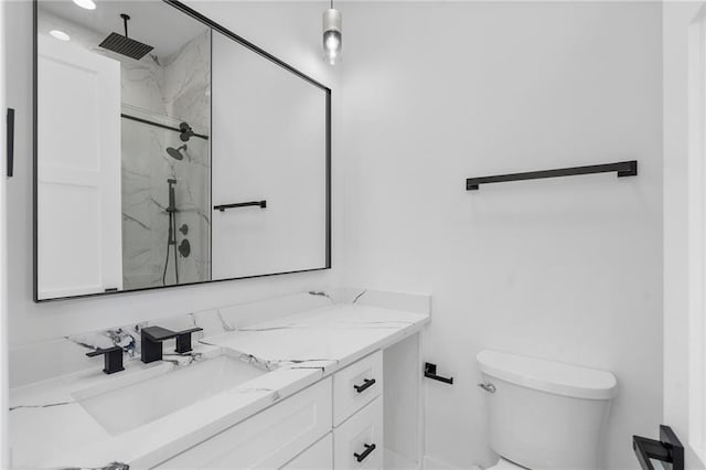 bathroom featuring vanity, toilet, and a shower