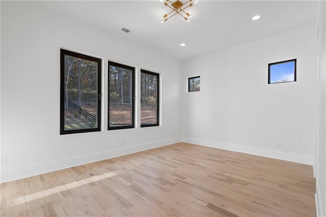 spare room with light hardwood / wood-style flooring