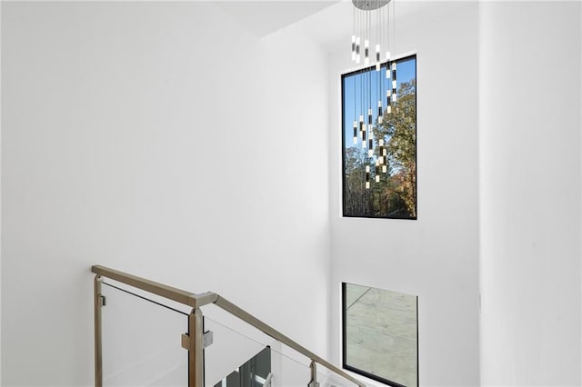 staircase featuring an inviting chandelier