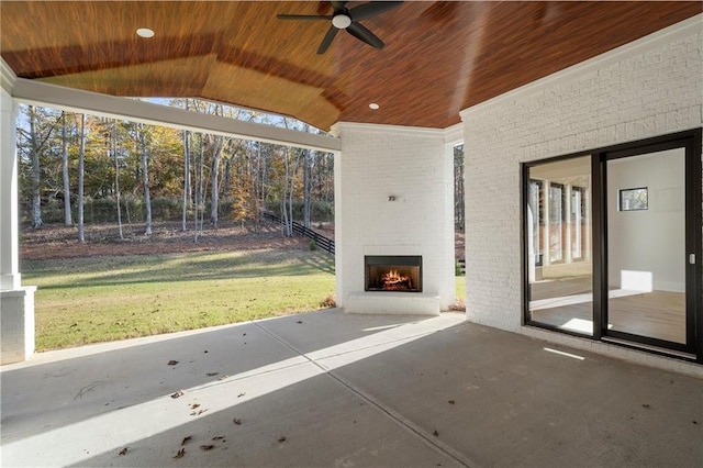 view of patio / terrace featuring an outdoor brick fireplace and ceiling fan