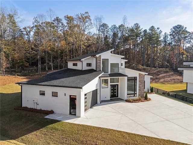 view of side of property with a lawn and a patio area