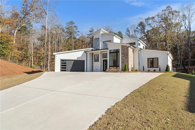 contemporary house with a garage and a front yard