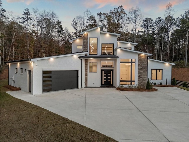 contemporary house featuring a garage and french doors