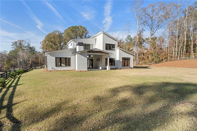 view of side of property with a lawn