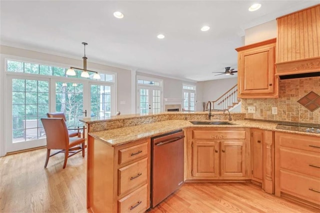 kitchen with a sink, stainless steel dishwasher, black electric stovetop, light wood-type flooring, and recessed lighting