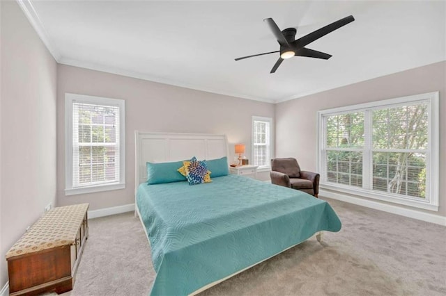 bedroom with multiple windows, crown molding, carpet floors, and baseboards