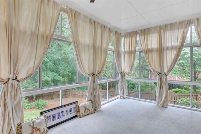 unfurnished sunroom with carpet flooring and healthy amount of natural light