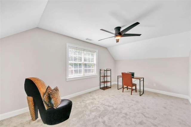 sitting room featuring vaulted ceiling, an office area, ceiling fan, carpet, and baseboards