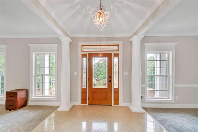 entryway with ornate columns, baseboards, a chandelier, and crown molding
