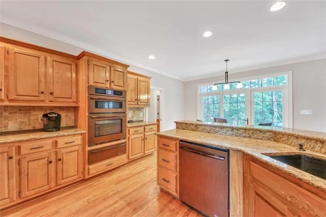 kitchen with stainless steel appliances, a warming drawer, decorative backsplash, light wood finished floors, and light stone counters