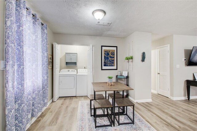 1351 Eason St NW, Atlanta, GA 30314 - dining room featuring light wood finished floors, washing machine and clothes dryer, and baseboards