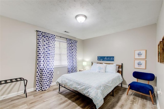 1351 Eason St NW, Atlanta, GA 30314 - bedroom with baseboards, a textured ceiling, visible vents, and wood finished floors