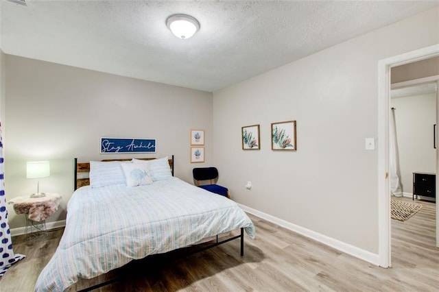 1351 Eason St NW, Atlanta, GA 30314 - bedroom featuring light wood finished floors, baseboards, and a textured ceiling