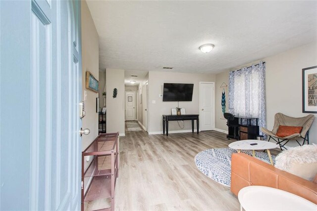 1351 Eason St NW, Atlanta, GA 30314 - living room featuring visible vents, light wood-style flooring, and baseboards