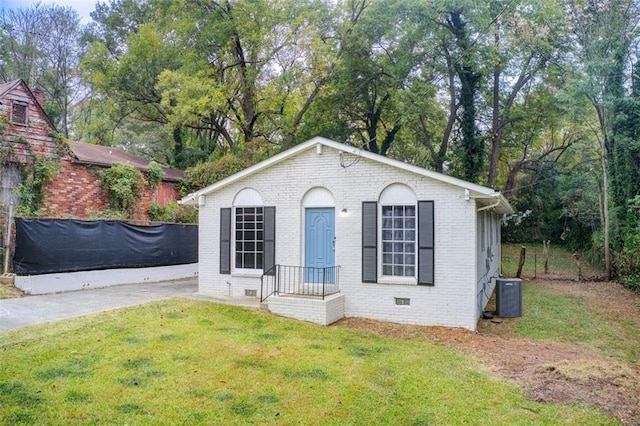 1351 Eason St NW, Atlanta, GA 30314 - view of front of house featuring a front lawn, crawl space, cooling unit, and brick siding