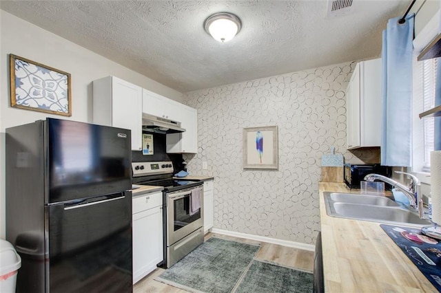 1351 Eason St NW, Atlanta, GA 30314 - kitchen featuring freestanding refrigerator, a sink, under cabinet range hood, stainless steel electric range, and wallpapered walls