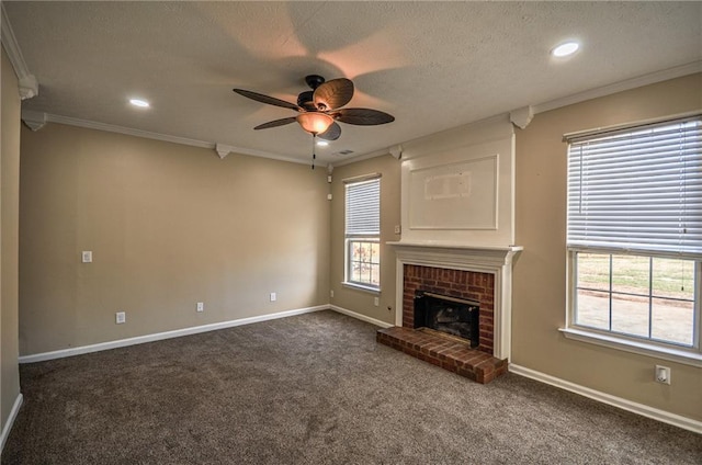 unfurnished living room with crown molding, a textured ceiling, dark carpet, ceiling fan, and a fireplace