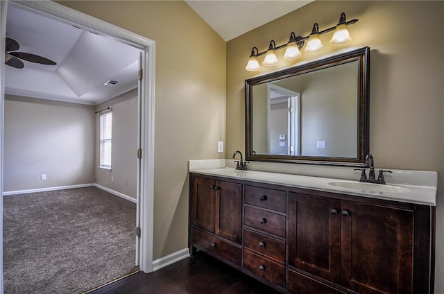 bathroom with hardwood / wood-style flooring, ceiling fan, vanity, and lofted ceiling