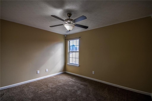 carpeted spare room with ceiling fan and a textured ceiling