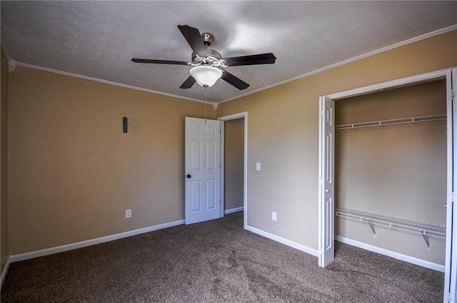 unfurnished bedroom with a textured ceiling, ornamental molding, a closet, ceiling fan, and carpet