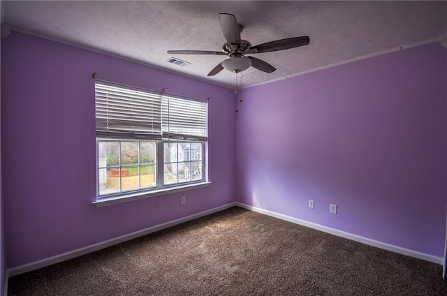 carpeted spare room featuring ceiling fan, crown molding, and a textured ceiling