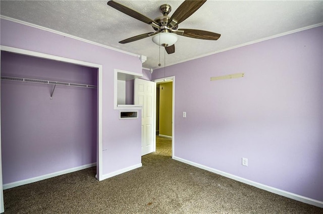 unfurnished bedroom with crown molding, ceiling fan, carpet floors, a textured ceiling, and a closet