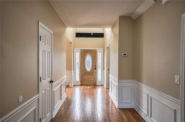 foyer featuring wood-type flooring and a textured ceiling