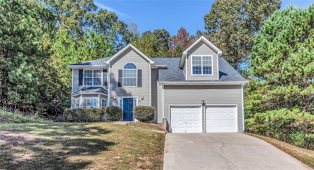 view of front of house with a garage and a front yard